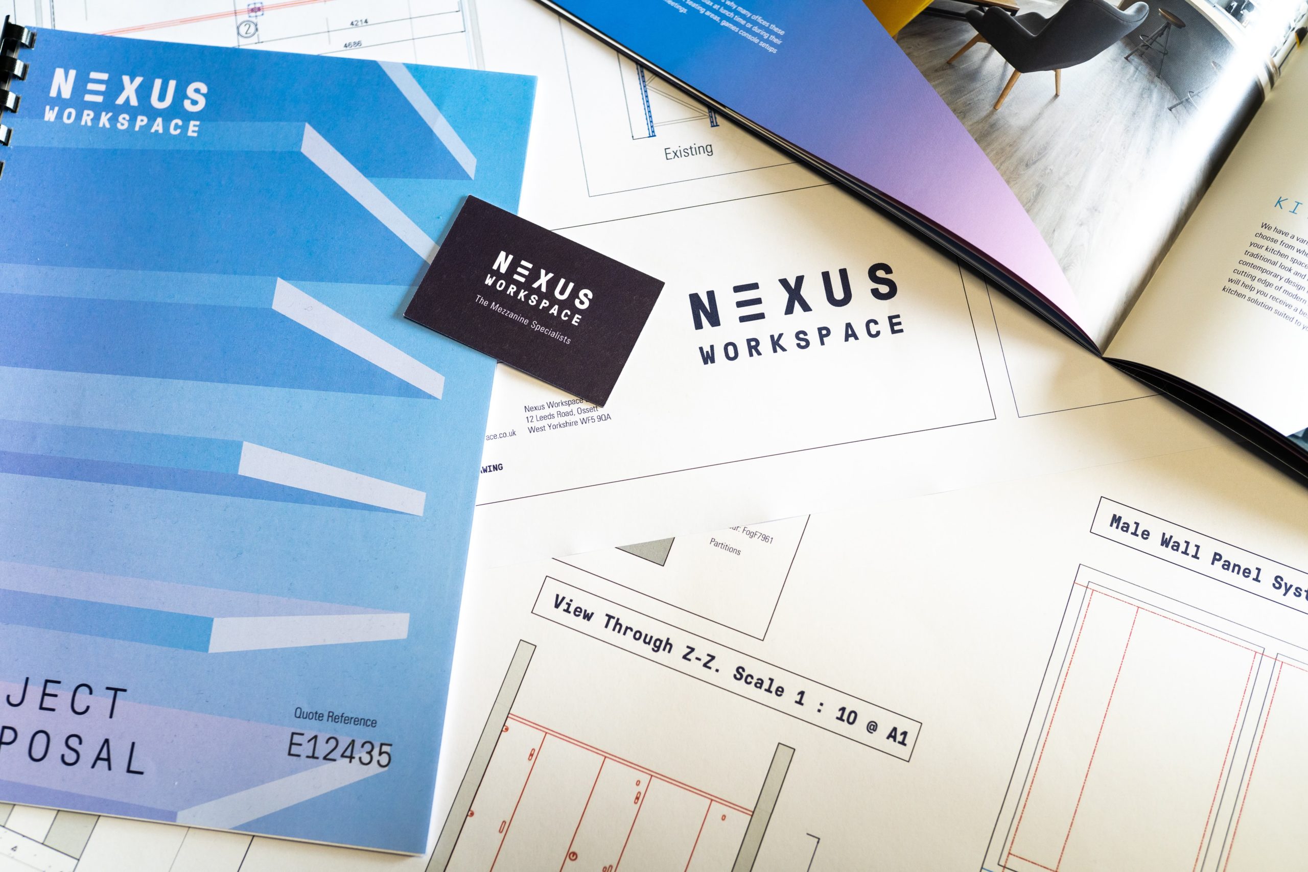 Meeting table with quotes, drawings, business cards and brochure